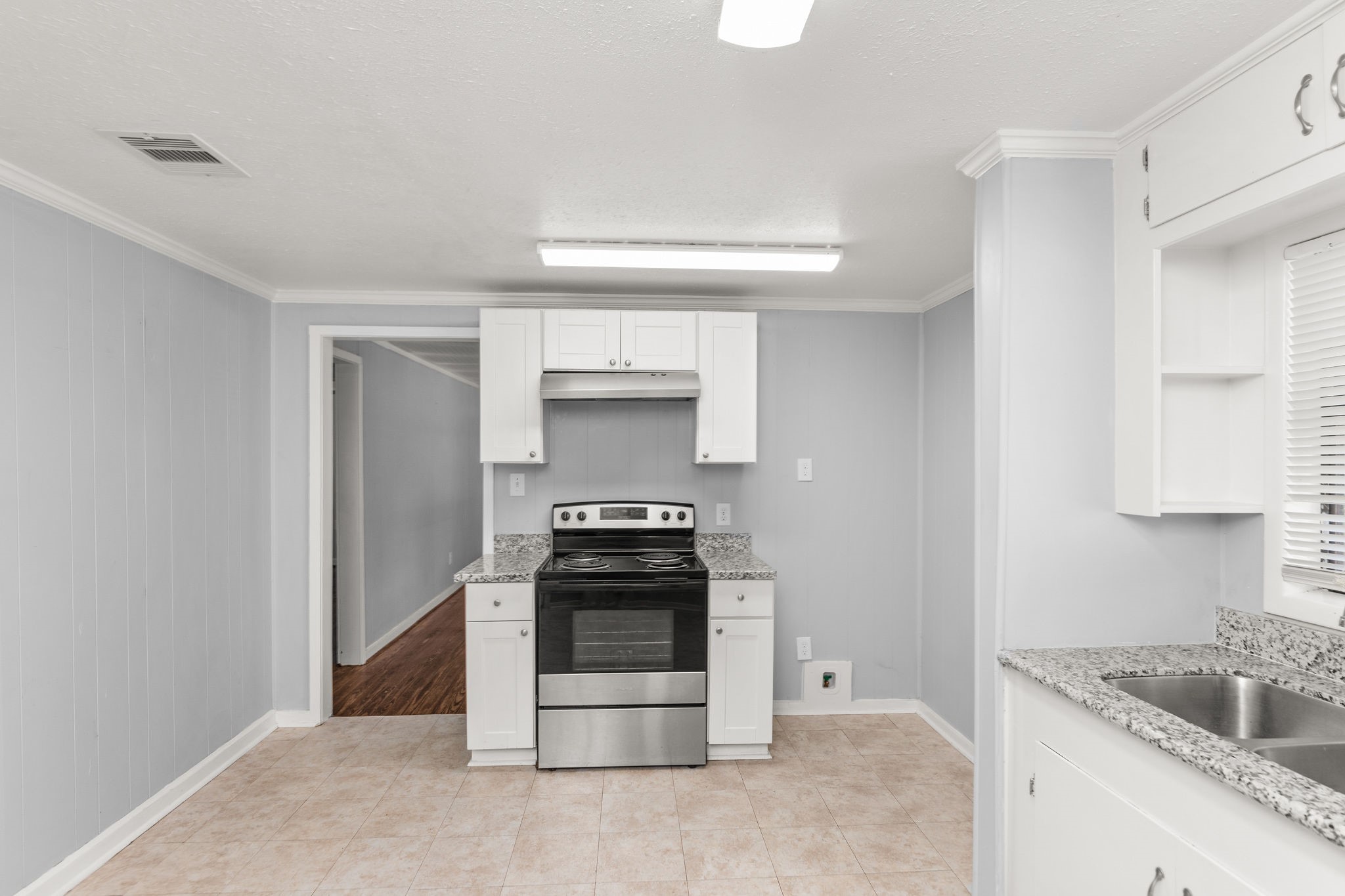 203 South Fig Street Sweeny, TX 77480 - Photo 9 of 20 a kitchen with a stove and a sink