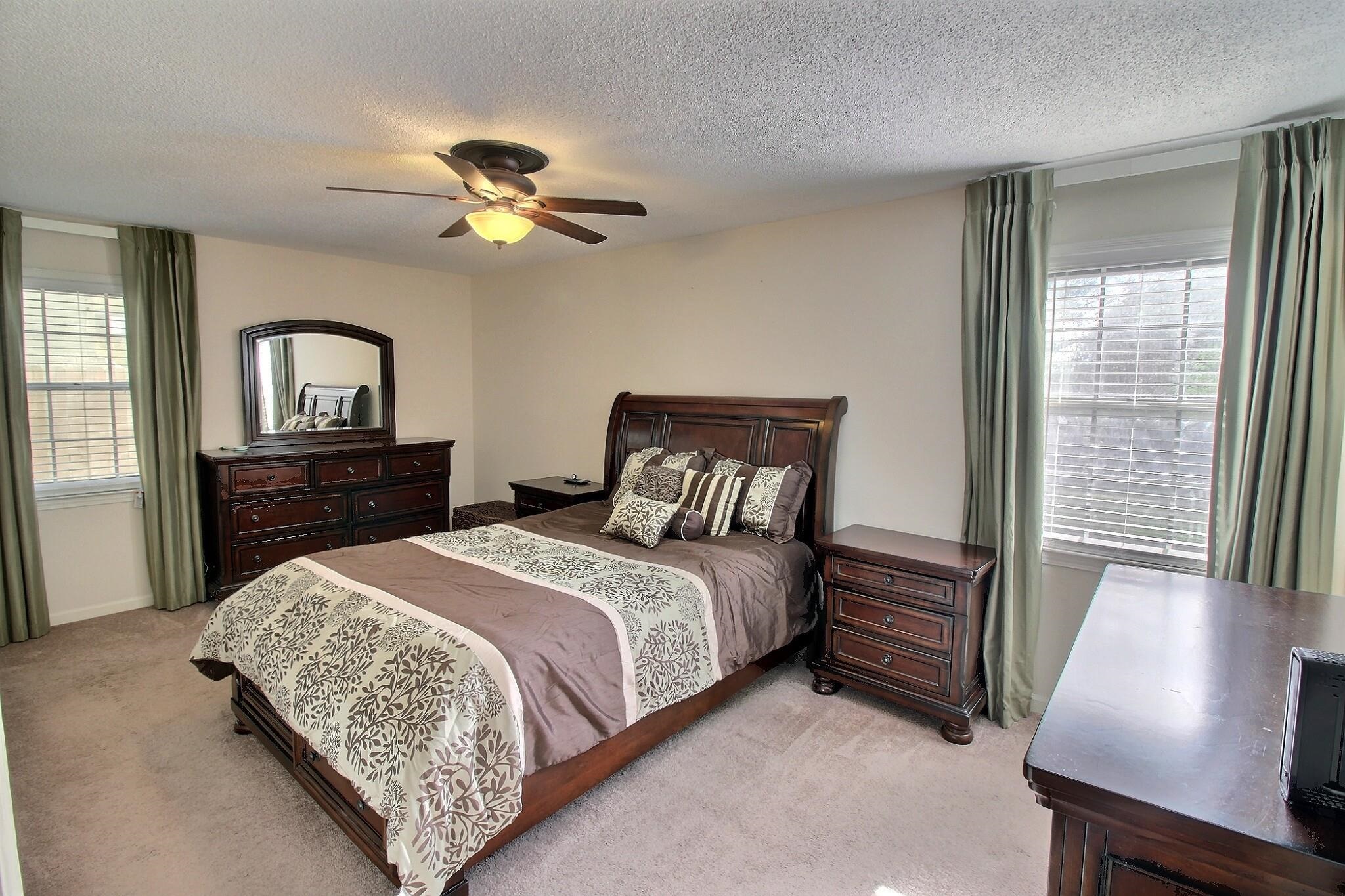 348 Rutledge Street Collierville, TN 38017 - Photo 11 of 19 a bedroom with a bed and a chandelier