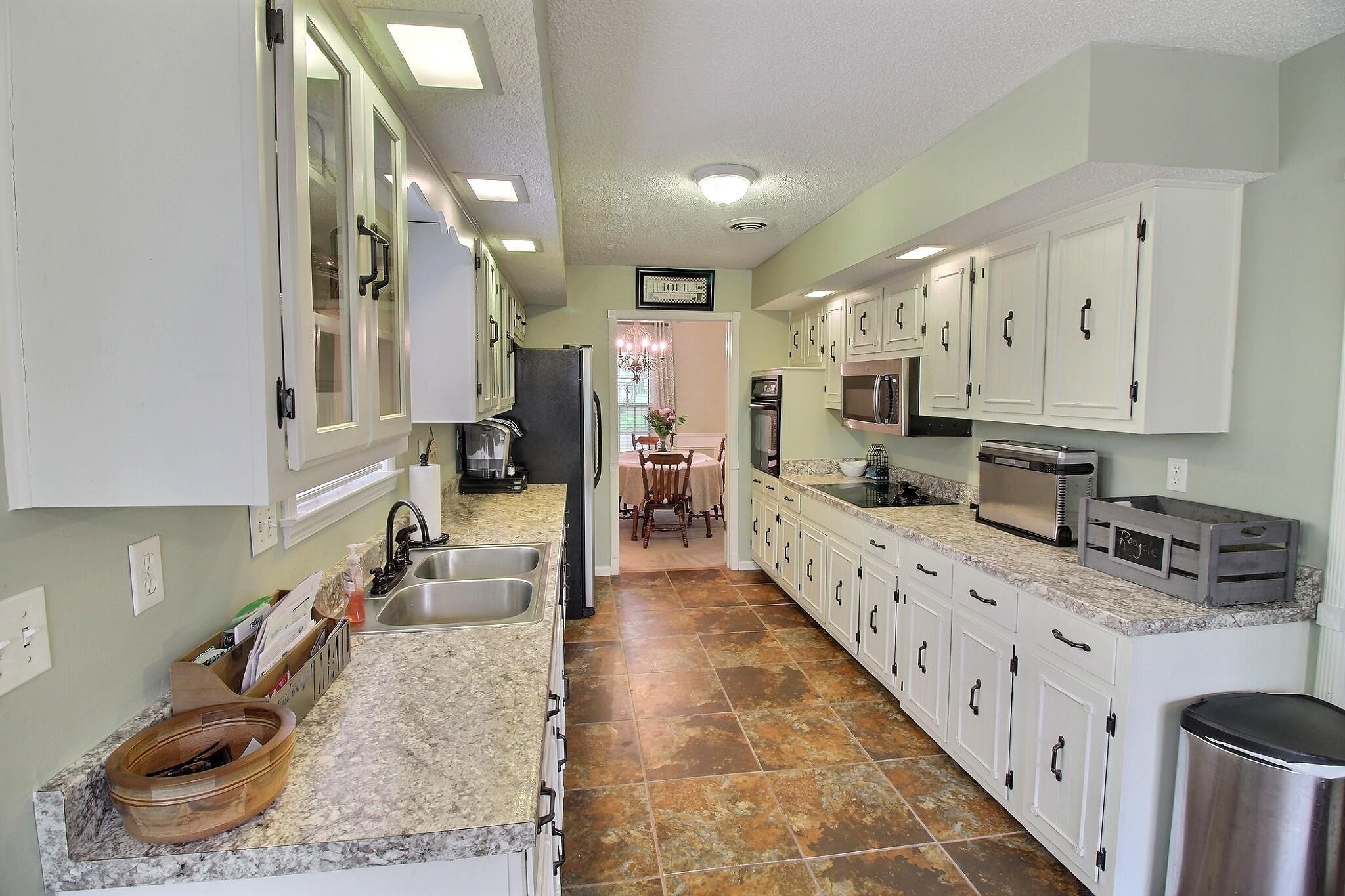 348 Rutledge Street Collierville, TN 38017 - Photo 8 of 19 a large white kitchen with stainless steel appliances granite countertop lots of counter top space
