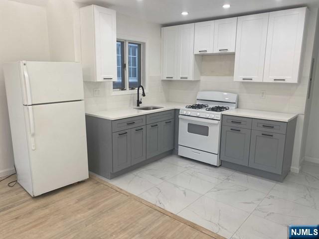 19-23 East Main Street, Unit B Ramsey, NJ 07446 - Photo 1 of 21 a kitchen with a white cabinets and white appliances