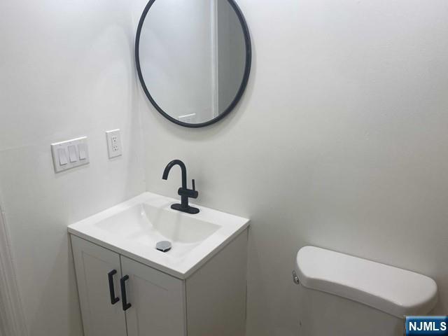 19-23 East Main Street, Unit B Ramsey, NJ 07446 - Photo 12 of 21 a bathroom with a sink and a mirror