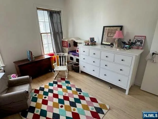 a room with a baby crib and a dresser