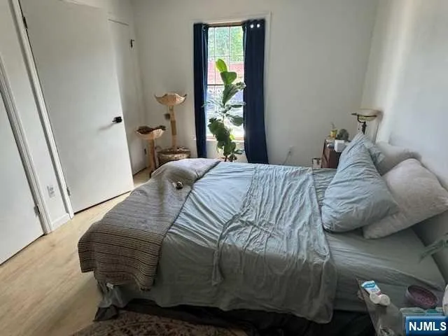 a bedroom with a bed and a window