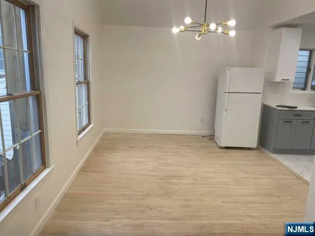 a view of a kitchen with a sink and refrigerator