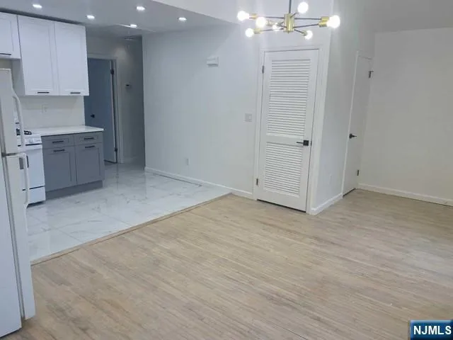 an empty room with kitchen appliances and cabinets