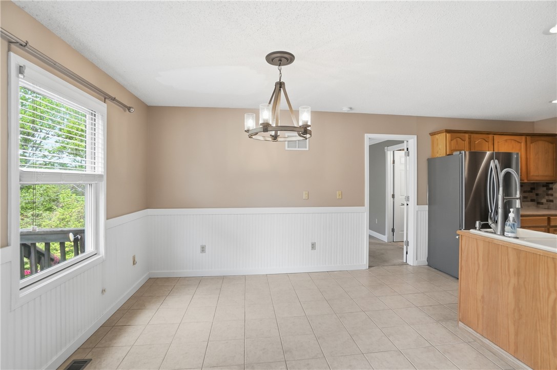 1208 Jarva Lane Springboro, OH 45066 - Photo 21 of 75 This bright dining area features beadboard wainscoting and durable tile flooring, perfect for gatherings.