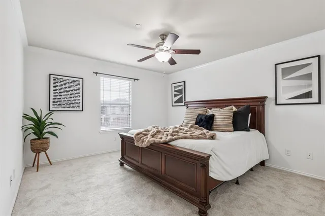 a bedroom with a bed and ceiling fan