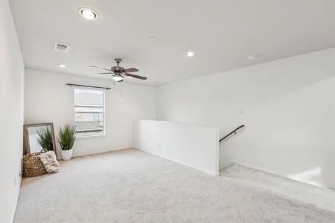 a bedroom with a bed and ceiling fan