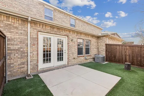 an aerial view of a house with swimming pool and outdoor seating