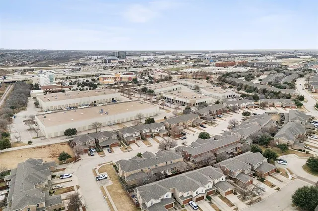 an aerial view of a house with swimming pool and outdoor seating