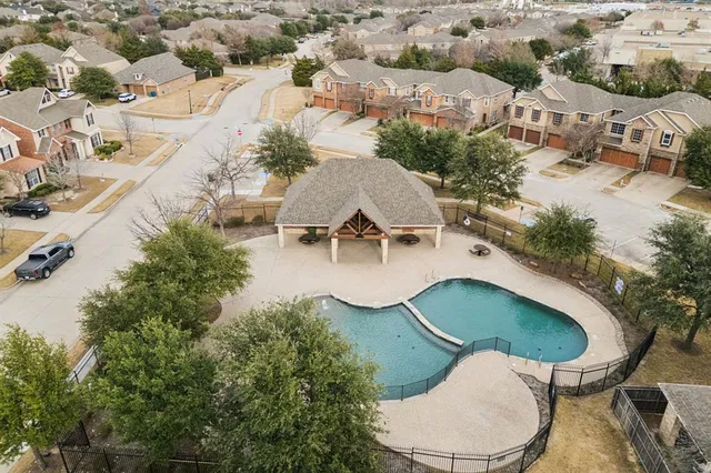 an aerial view of residential houses with outdoor space