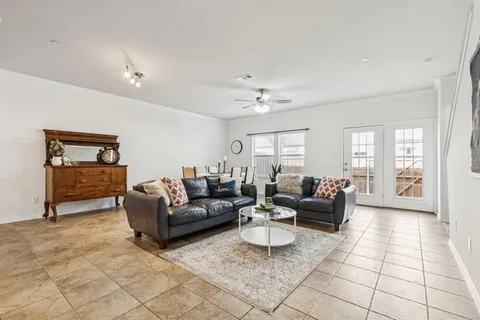 a living room with furniture a couch and a flat screen tv
