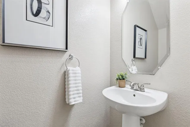 a bathroom with a sink a mirror and a window