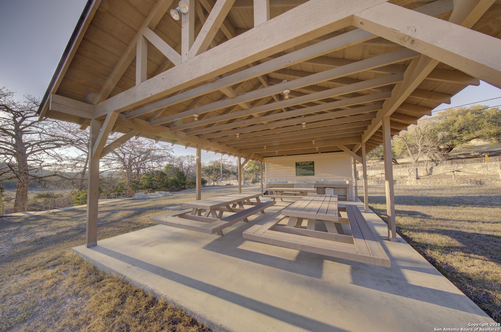 0 River Bend Road West Hunt, TX 78024 - Photo 55 of 55 a view of a patio with table and chairs with wooden floor and fence