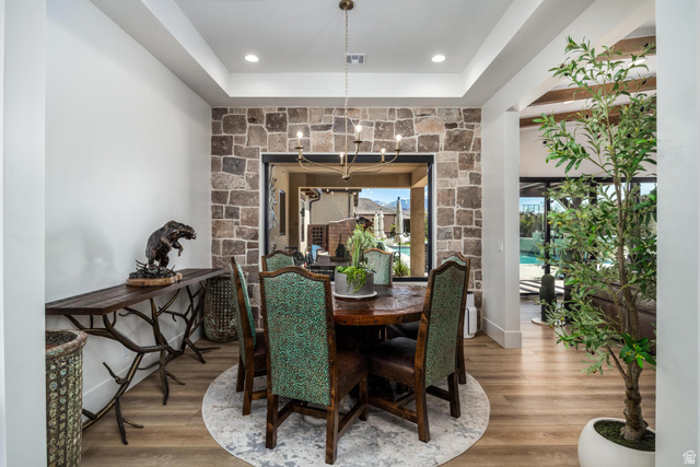 168 South Rancho Santa Fe Virgin, UT 84779 - Photo 11 of 68 Stone accent wall with a passthrough window, wood-finish flooring, and recessed ceiling lighting