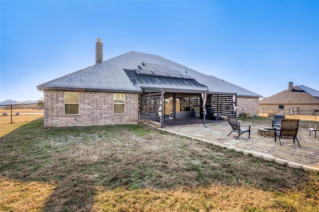 7417 Green Mesa Road Ponder, TX 76259 - Photo 33 of 39 a backyard of a house with barbeque oven table and chairs