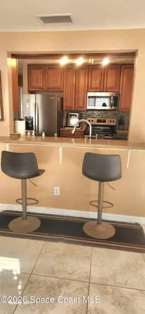 a kitchen with a counter and a refrigerator