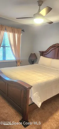 a view of walk in closet and window in a room