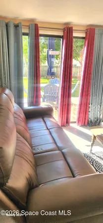 a living room with a couch and a large window