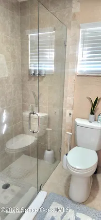 a bathroom with a toilet and a shower