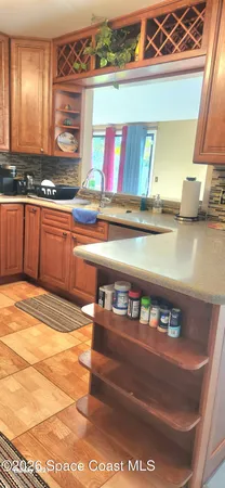 a kitchen with a sink a stove and cabinets