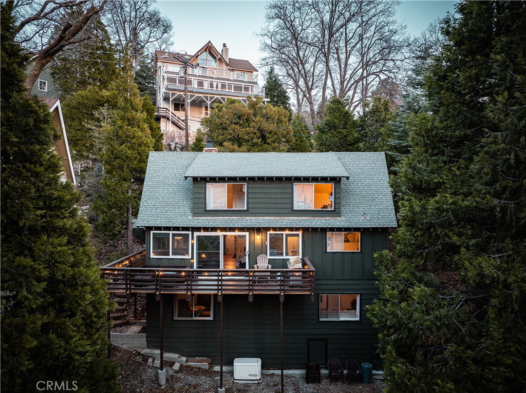 a front view of a house with yard and trees