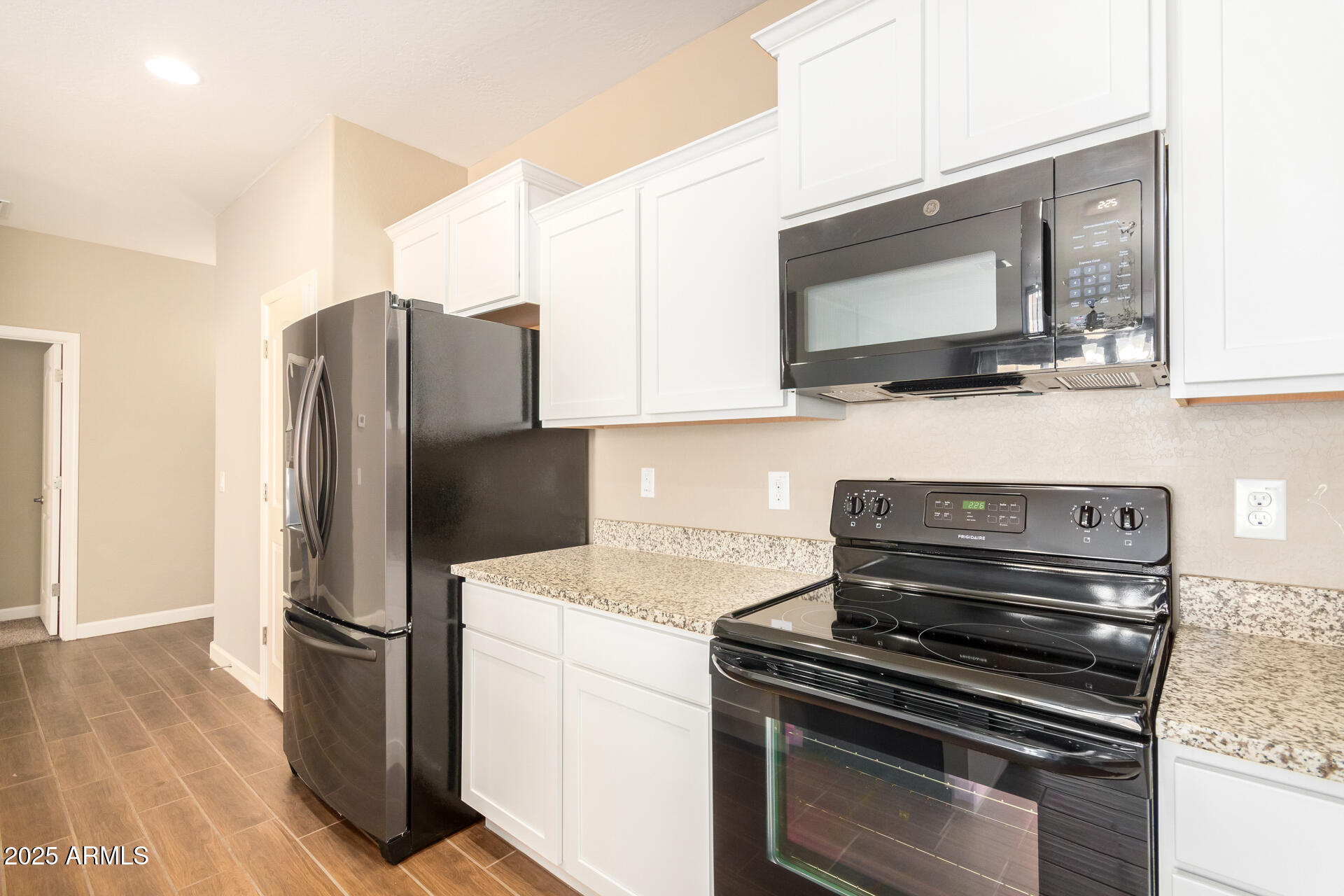 23882 West Ripple Road Buckeye, AZ 85326 - Photo 12 of 30 a kitchen with a refrigerator stove and microwave
