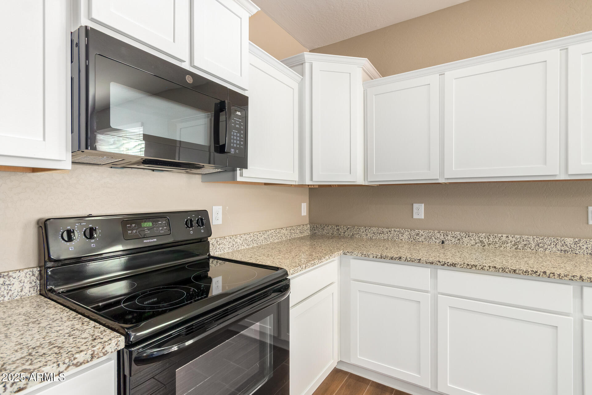 23882 West Ripple Road Buckeye, AZ 85326 - Photo 14 of 30 a kitchen with a stove and a microwave