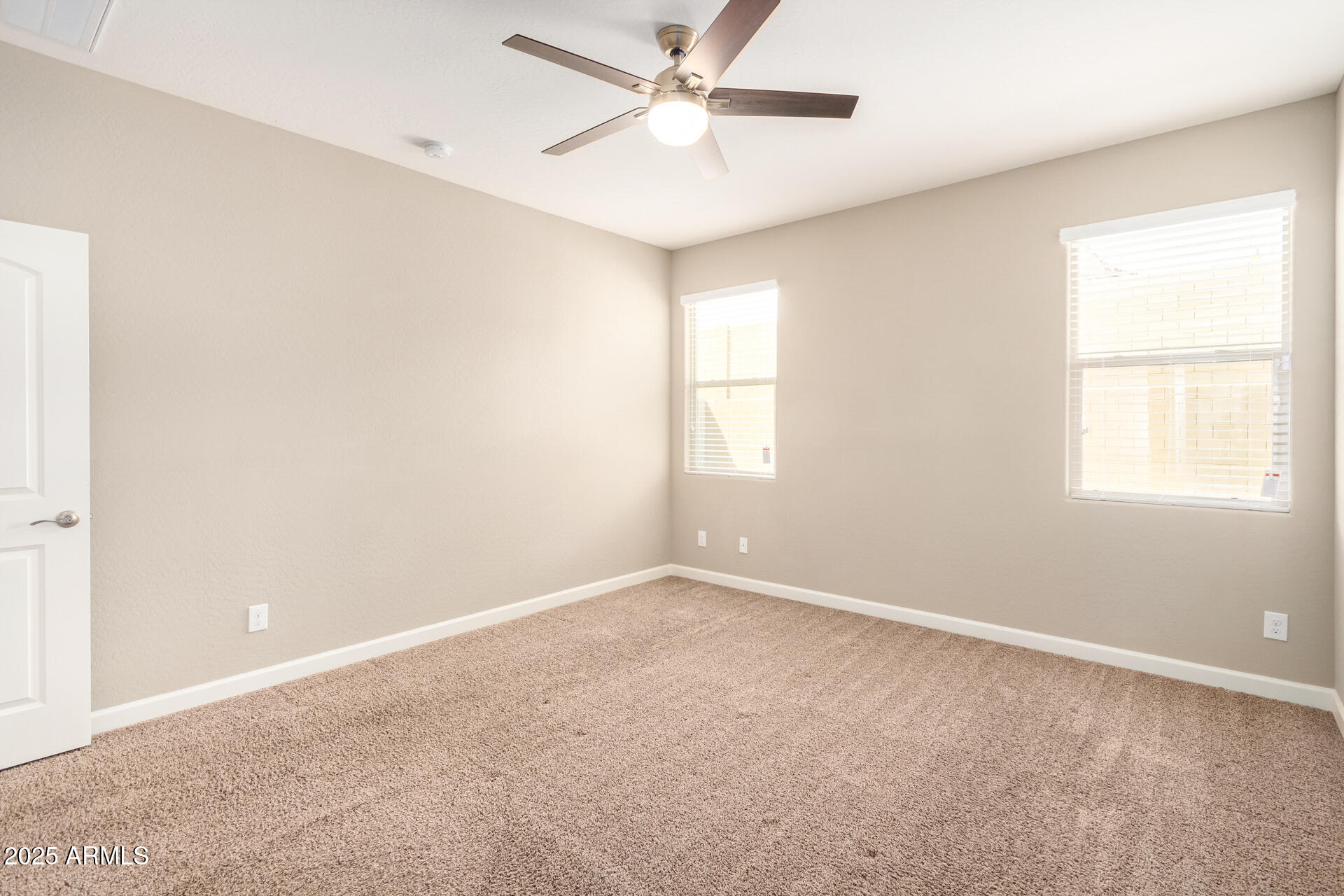 23882 West Ripple Road Buckeye, AZ 85326 - Photo 16 of 30 an empty room with windows and fan