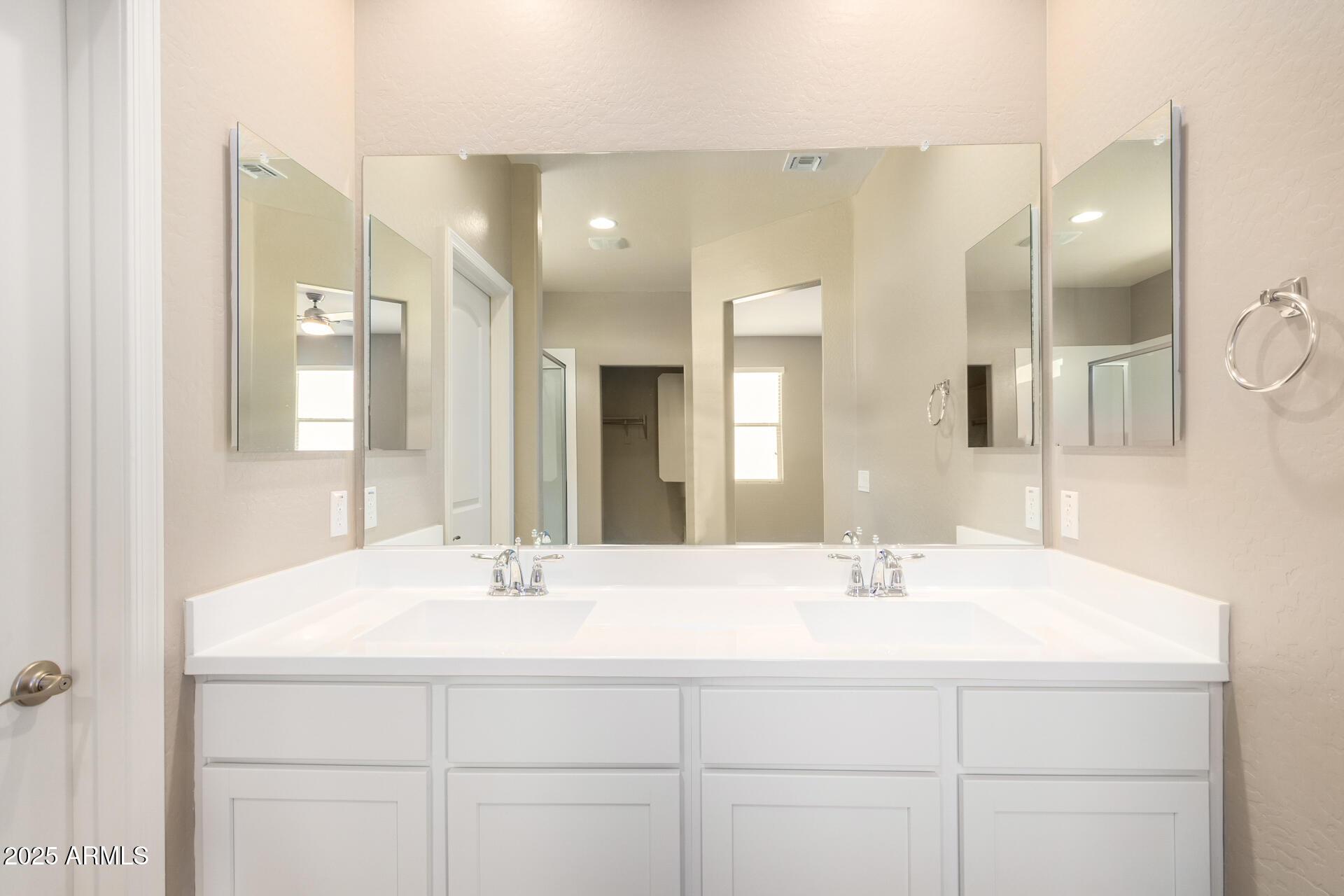 23882 West Ripple Road Buckeye, AZ 85326 - Photo 17 of 26 a bathroom with a sink and a mirror