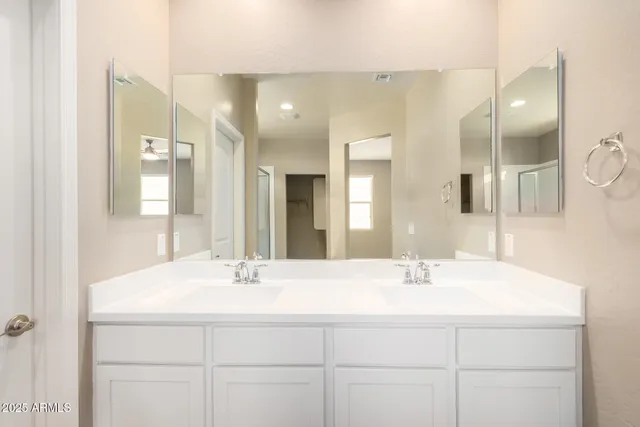 a bathroom with a mirror and a shower