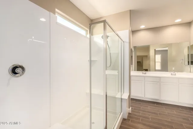 a bathroom with a glass shower door