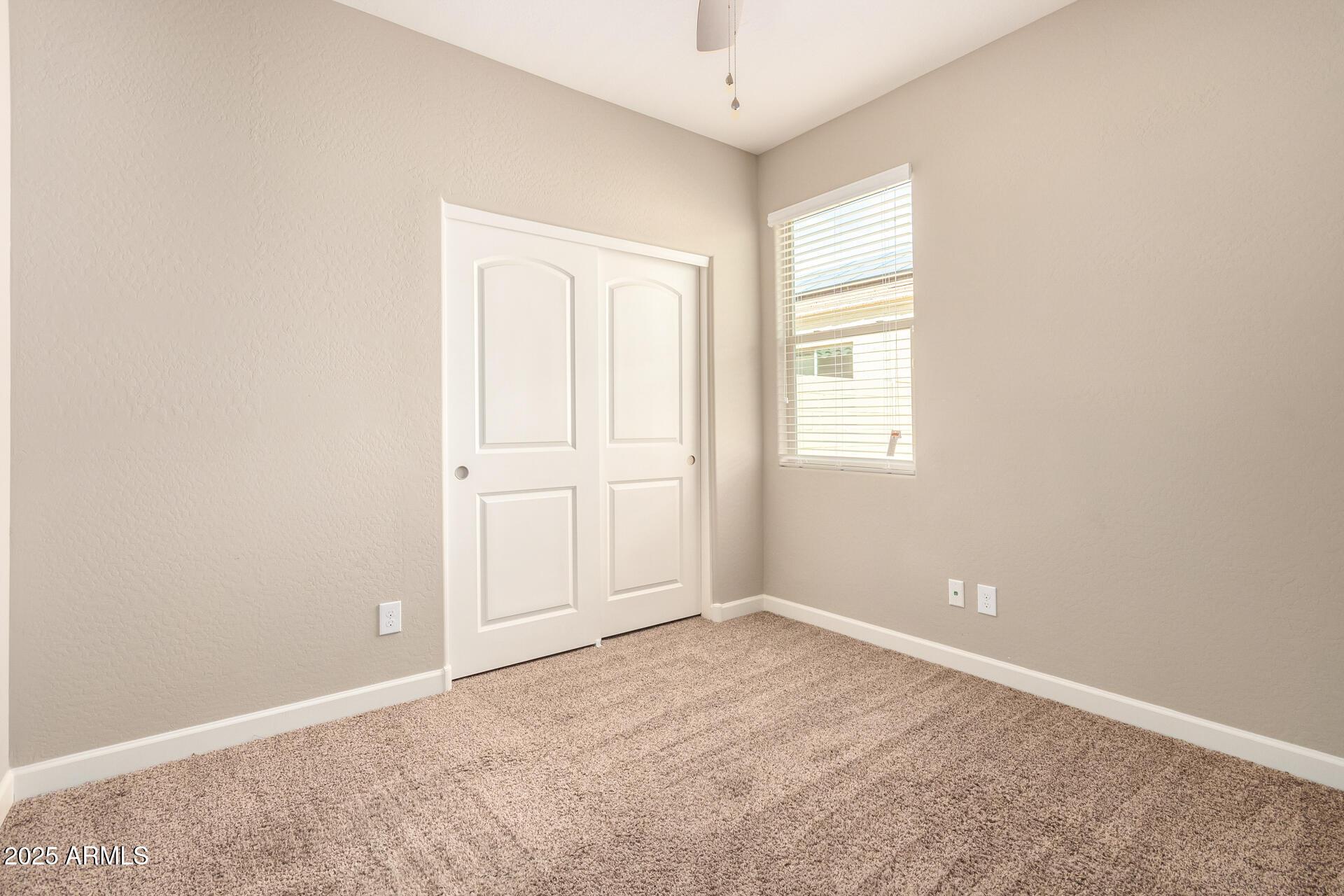 23882 West Ripple Road Buckeye, AZ 85326 - Photo 22 of 26 an empty room with windows