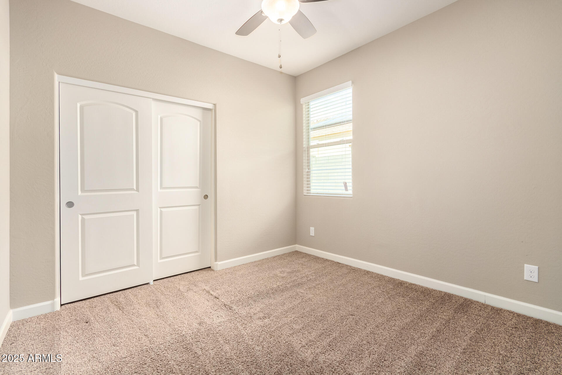 23882 West Ripple Road Buckeye, AZ 85326 - Photo 23 of 30 an empty room with a window and a ceiling fan