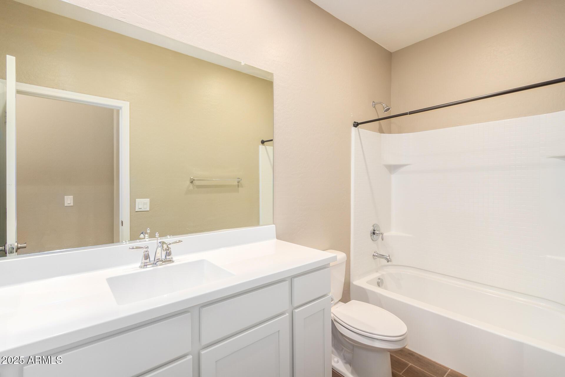 23882 West Ripple Road Buckeye, AZ 85326 - Photo 24 of 26 a bathroom with a sink a toilet and shower