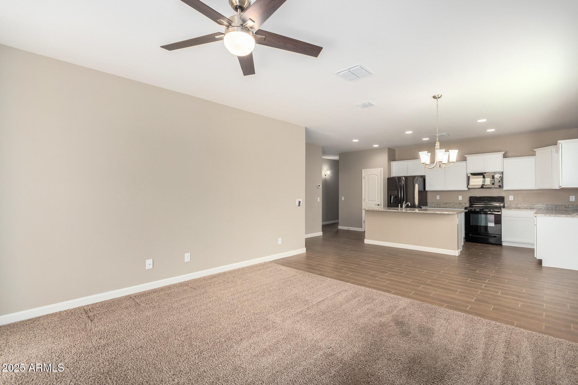 23882 West Ripple Road Buckeye, AZ 85326 - Photo 6 of 30 a view of a kitchen with a sink and a stove top oven