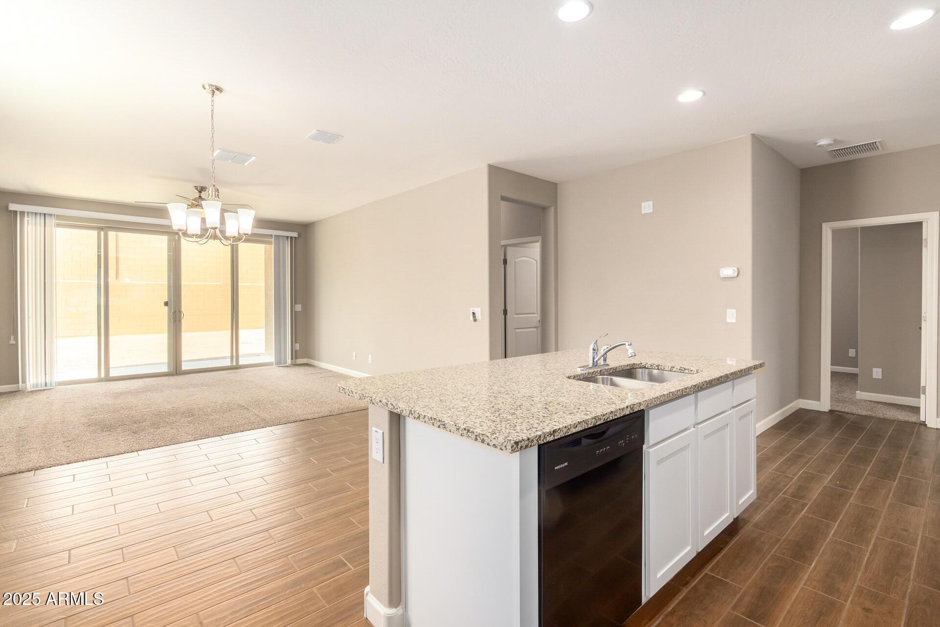 23882 West Ripple Road Buckeye, AZ 85326 - Photo 10 of 26 a bathroom with a granite countertop sink a vanity and a large mirror