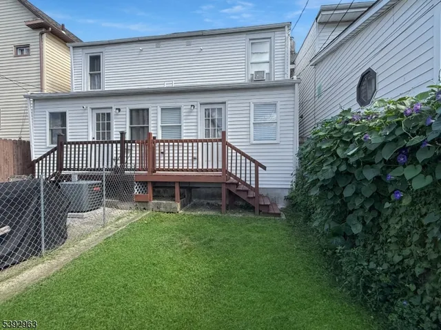a backyard of a house with a garden and deck