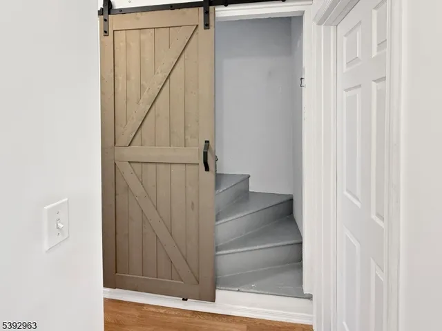 a view of staircase with white walls and railing