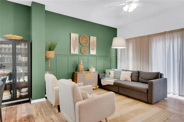 a living room with furniture and a potted plant