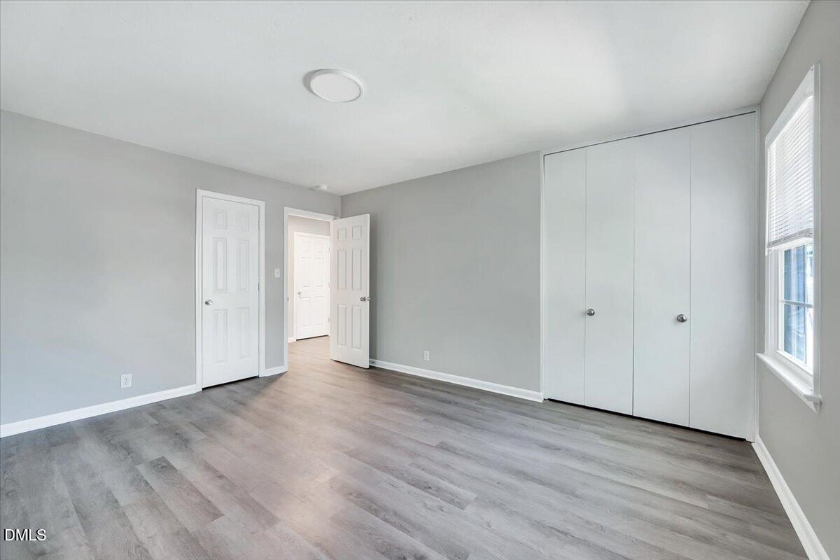 3408 Atlantic Avenue Raleigh, NC 27604 - Photo 36 of 48 a view of an empty room with wooden floor and entryway