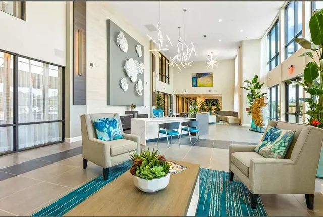 a living room with furniture and a large window