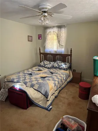 a bedroom with a bed mirror and window