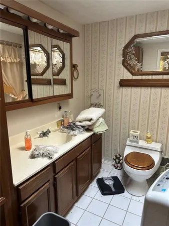 a bathroom with a sink toilet and mirror