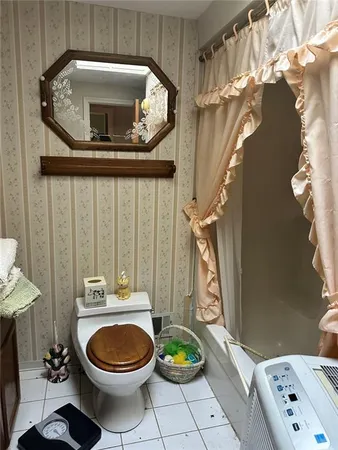 a bathroom with a toilet mirror and vanity