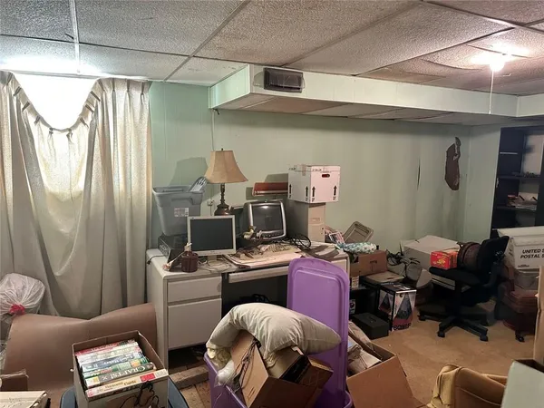 a view of a workspace with furniture and a window