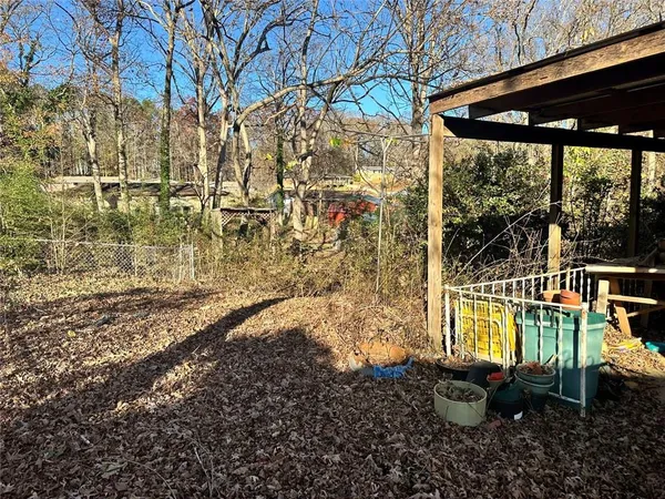a view of a small yard with wooden fence