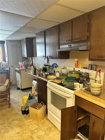 a kitchen with a stove a refrigerator and cabinets