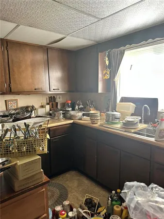 a kitchen with a sink and a stove top oven