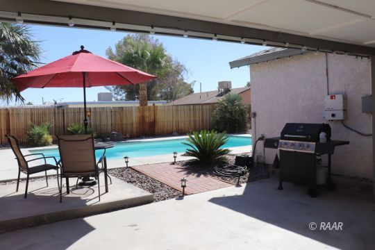 318 South Gordon Street Ridgecrest, CA 93555 - Photo 23 of 27 a view of a backyard with furniture and a table
